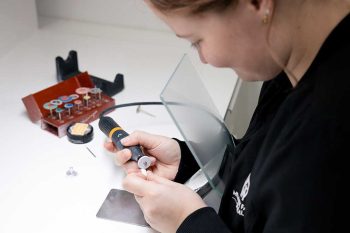 Millcreek Family Dental team member working on a CEREC tooth using a specialized Dremel