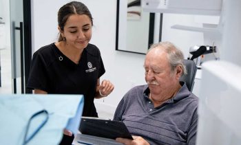 Millcreek Family Dental patient reviewing forms with a team member