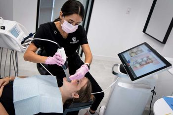 Patient having their mouth examined using an intraoral camera