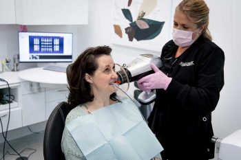Millcreek Family Dental team member performing an x-ray on a patient